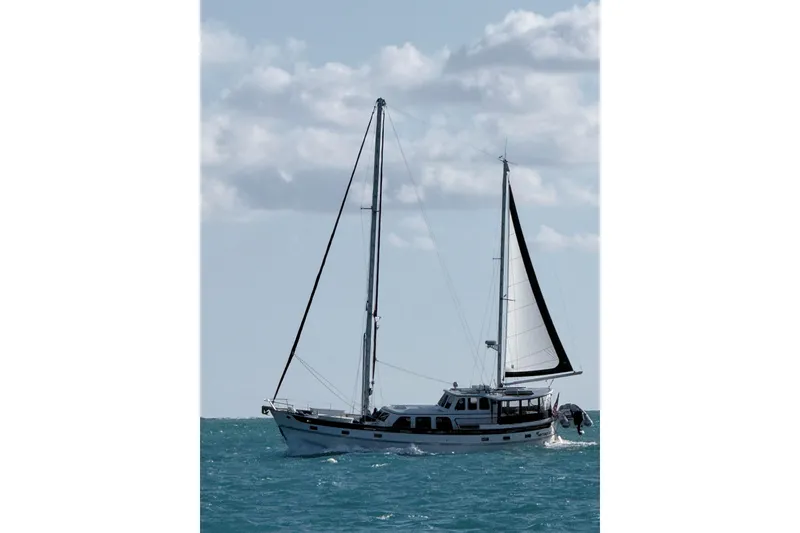 Slide: The Image of 1980 Cheoy Lee 52 Motorsailer sailing on open sea under cloudy sky. - 1