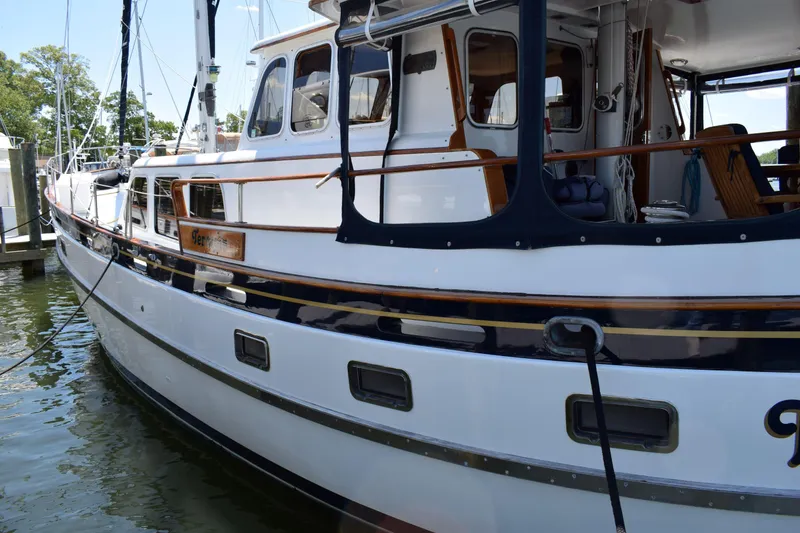 Slide: The Image of 1980 Cheoy Lee 52 Motorsailer docked, showcasing elegant design and classic nautical features. - 10