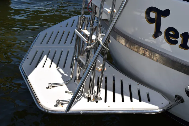 Slide: The Image of Stern view of 1980 Cheoy Lee 52 Motorsailer with swim platform and ladder. - 12