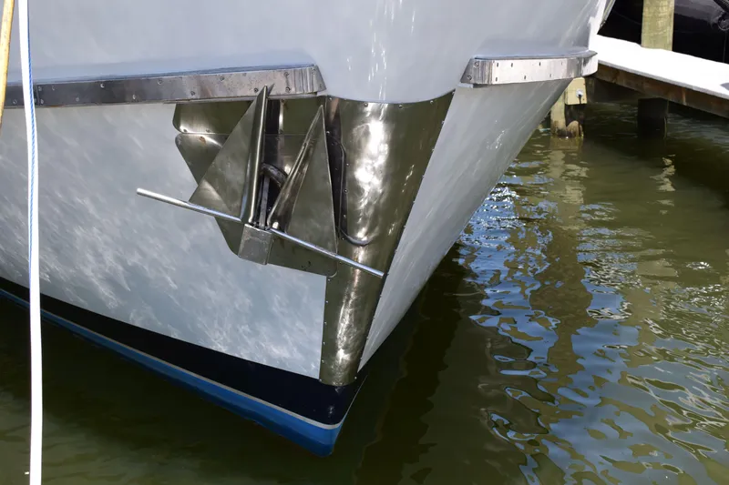 Slide: The Image of Bow of 1980 Cheoy Lee 52 Motorsailer with anchor, docked in calm water. - 4