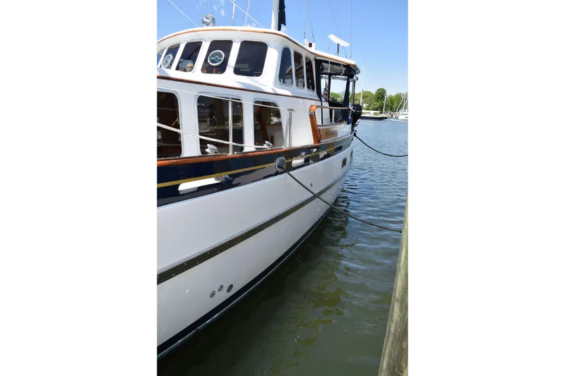 Slide: The Image of 1980 Cheoy Lee 52 Motorsailer docked on calm water, showcasing classic design. - 7