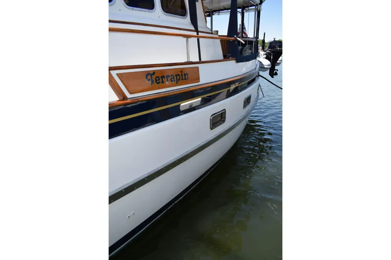 Slide: The Image of 1980 Cheoy Lee 52 Motorsailer "Terrapin" docked, showcasing elegant wooden accents. - 8