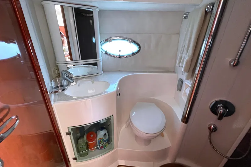 Slide: The Image of Bathroom interior of 2004 Fairline Targa 40 yacht, featuring sink, toilet, and porthole window. - 12