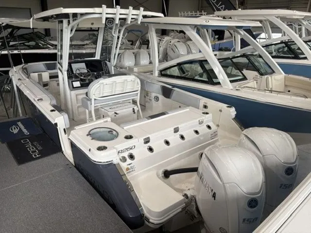 Slide: The Image of 2026 Robalo R250 Center Console boat in showroom. - 2