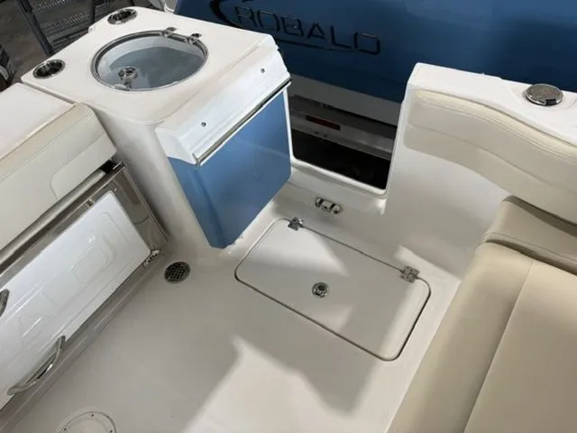 Slide: The Image of Interior of 2026 Robalo R257 Dual Console with seating and storage area. - 12