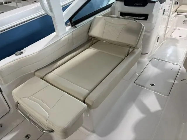 Slide: The Image of Interior of 2026 Robalo R257 Dual Console with beige seating area. - 3