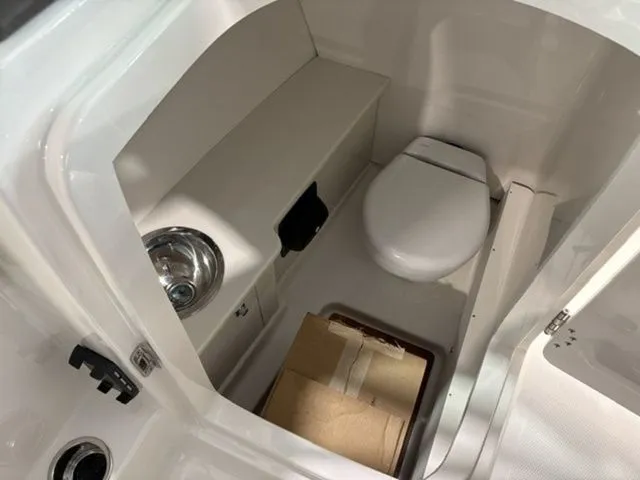 Slide: The Image of Interior of 2026 Robalo R257 Dual Console with toilet. - 7