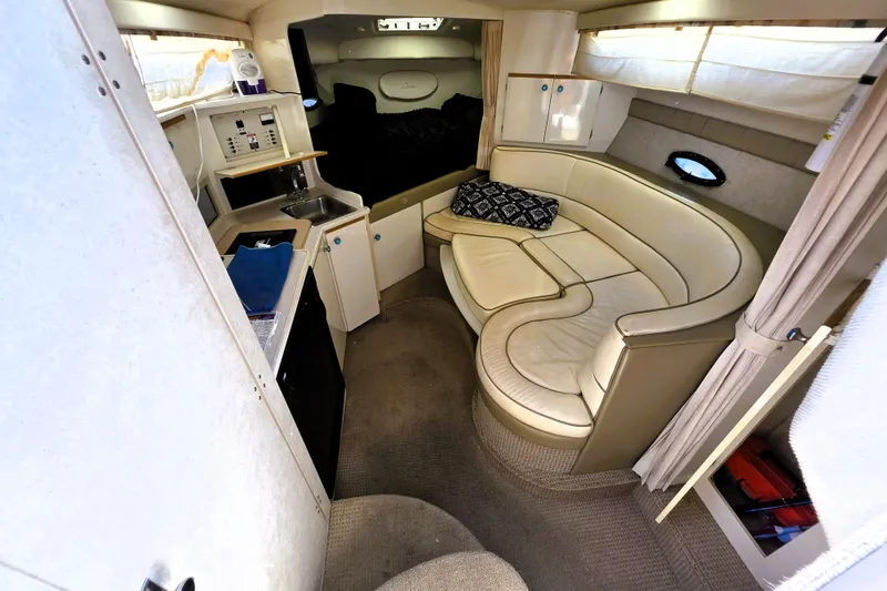 Slide: The Image of Interior of 1999 Bayliner 3055 Ciera boat with cozy seating and kitchenette. - 10