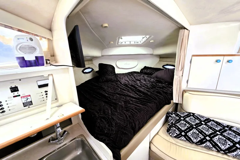 Slide: The Image of Interior of a 1999 Bayliner 3055 Ciera boat with cozy sleeping area and modern amenities. - 18