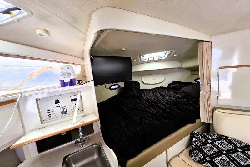 Slide: The Image of 1999 Bayliner 3055 Ciera cabin interior with bed, sink, and control panel. - 20