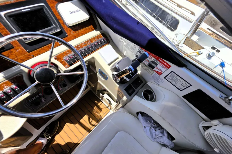 Slide: The Image of Cockpit of 1999 Bayliner 3055 Ciera boat with steering wheel and control panel. - 8