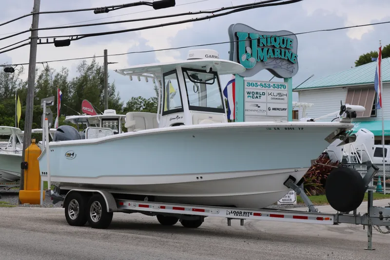 Slide: The Image of 2023 Sea Hunt Gamefish 25 boat on trailer at Unique Marine dealership. - 1