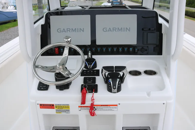 Slide: The Image of 2023 Sea Hunt Gamefish 25 helm with dual Garmin displays and modern controls. - 10