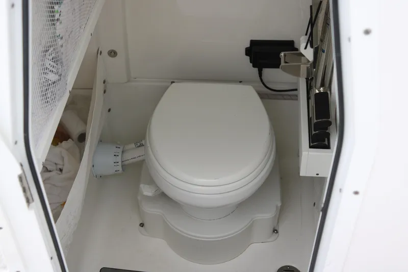 Slide: The Image of 2023 Sea Hunt Gamefish 25 boat interior with compact marine toilet. - 14