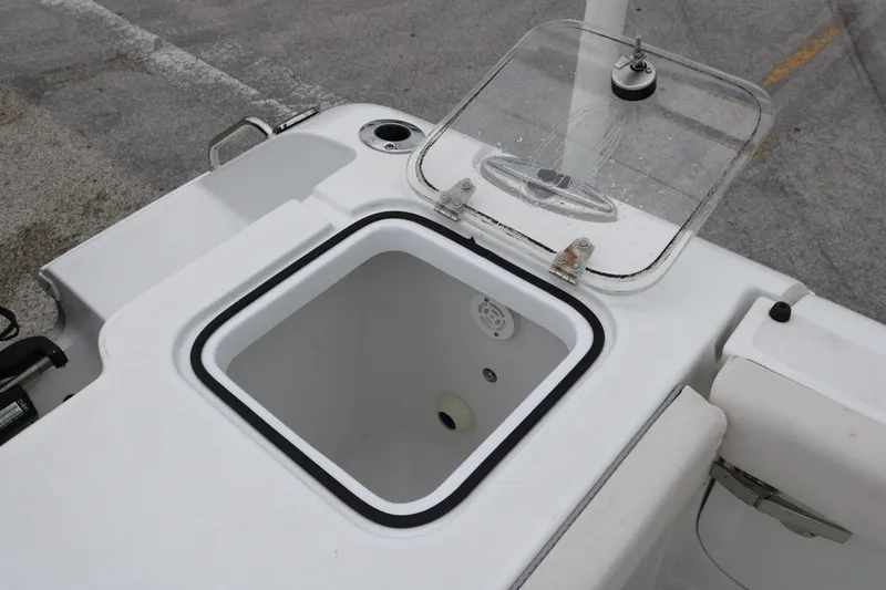 Slide: The Image of Livewell compartment on 2023 Sea Hunt Gamefish 25 boat, featuring a clear lid and white interior. - 16