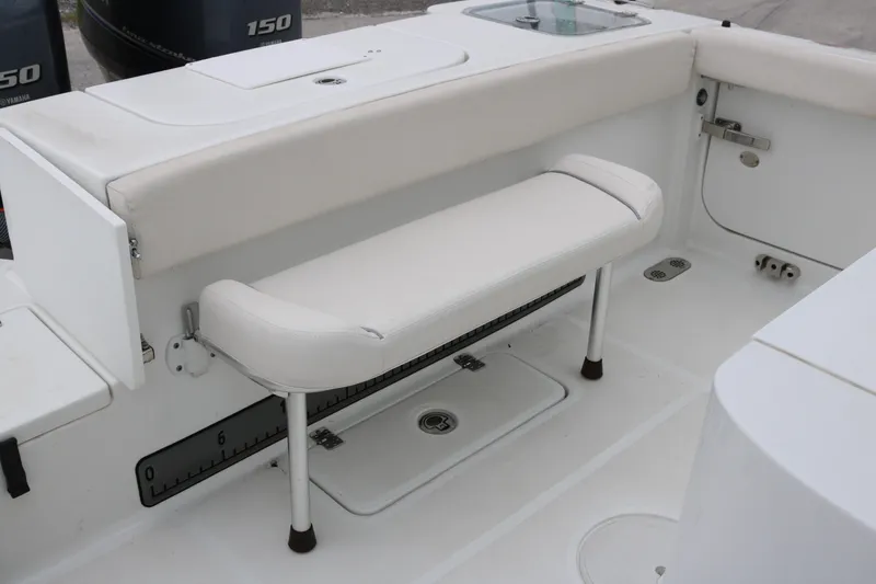Slide: The Image of 2023 Sea Hunt Gamefish 25 boat interior with white seating and storage compartments. - 18