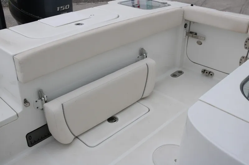Slide: The Image of 2023 Sea Hunt Gamefish 25 boat interior with white seating and storage compartments. - 19
