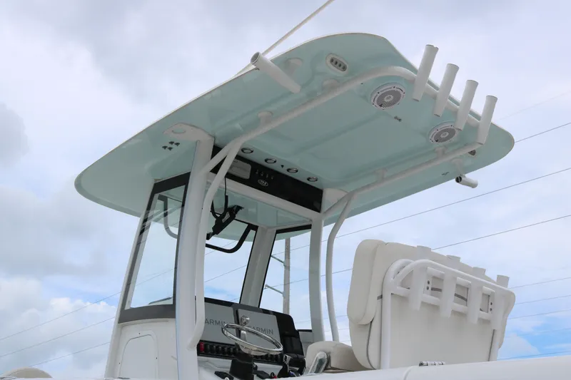 Slide: The Image of 2023 Sea Hunt Gamefish 25 boat with T-top and rod holders against cloudy sky. - 5