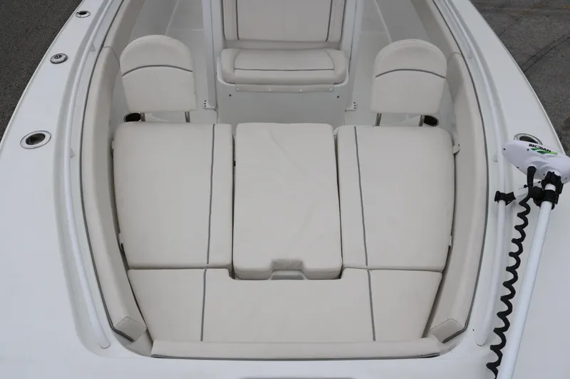Slide: The Image of 2023 Sea Hunt Gamefish 25 boat interior with cushioned seating and trolling motor. - 8