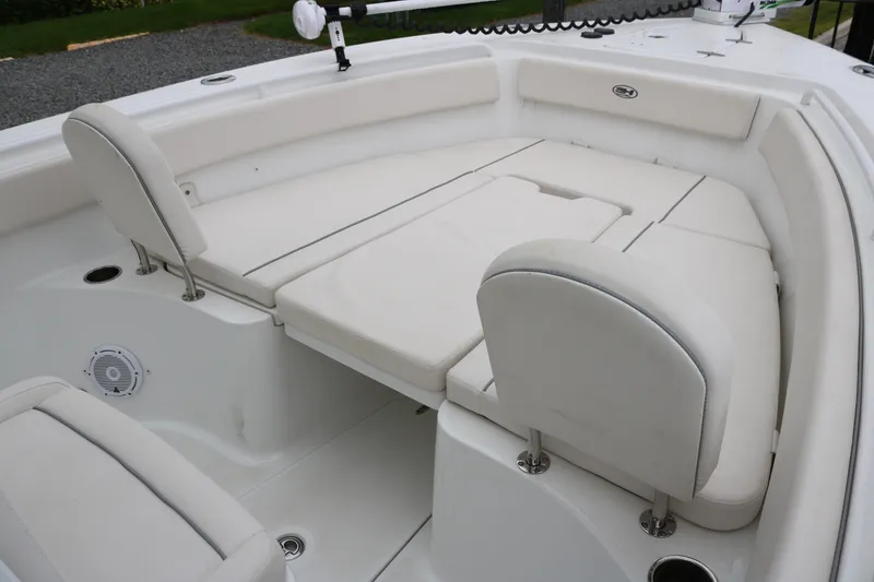 Slide: The Image of 2023 Sea Hunt Gamefish 25 boat interior with cushioned seating and storage compartments. - 9