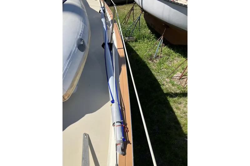 Slide: The Image of 1981 Pearson 365 Ketch sailboat deck with rigging, docked on grass. - 1