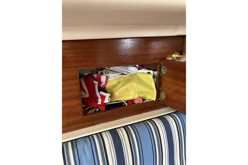 Slide: The Image of Storage compartment on a 1981 Pearson 365 Ketch with colorful items inside. - 14