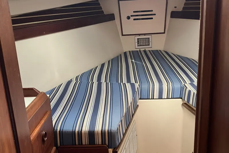 Slide: The Image of Interior cabin of 1981 Pearson 365 Ketch with striped cushions and wooden accents. - 20