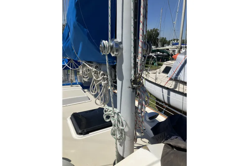 Slide: The Image of 1981 Pearson 365 Ketch sailboat deck with rigging and blue sail cover. - 3