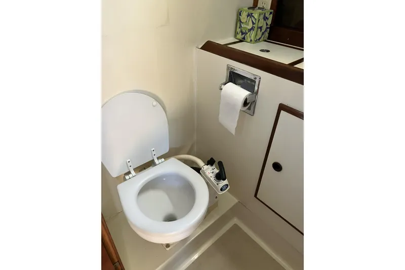 Slide: The Image of 1981 Pearson 365 Ketch boat bathroom with toilet and toilet paper holder. - 31