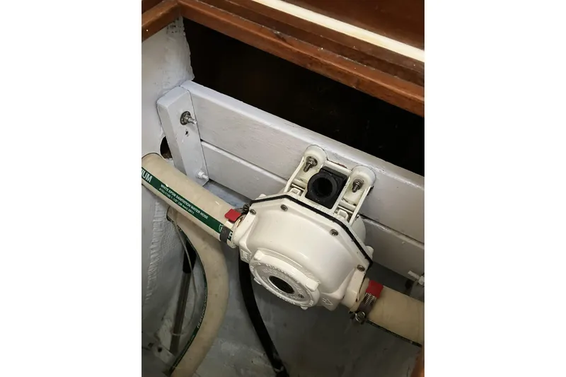 Slide: The Image of Engine compartment of a 1981 Pearson 365 Ketch sailboat, featuring hoses and mechanical components. - 32