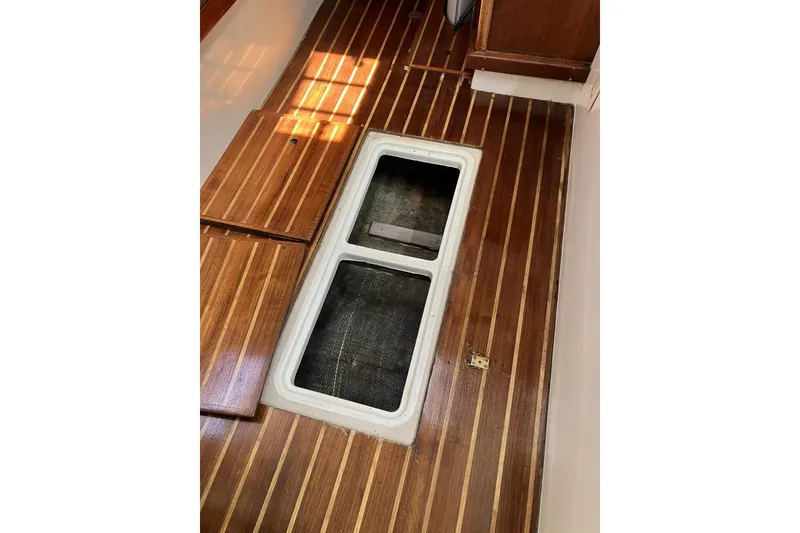 Slide: The Image of Wooden floor with open hatch on 1981 Pearson 365 Ketch sailboat. - 33
