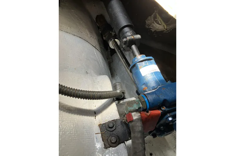 Slide: The Image of Engine compartment of a 1981 Pearson 365 Ketch, featuring hydraulic components and wiring. - 34