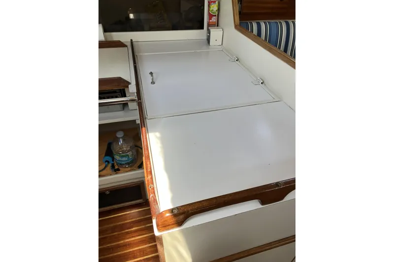 Slide: The Image of Interior of 1981 Pearson 365 Ketch sailboat with white cabinetry and wooden accents. - 36