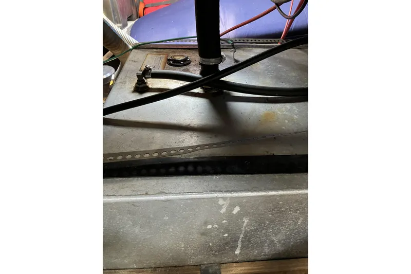 Slide: The Image of Engine compartment of a 1981 Pearson 365 Ketch sailboat, showing cables and metal components. - 38