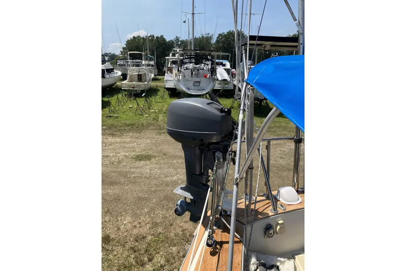Slide: The Image of 1981 Pearson 365 Ketch sailboat with outboard motor, docked among other boats. - 41