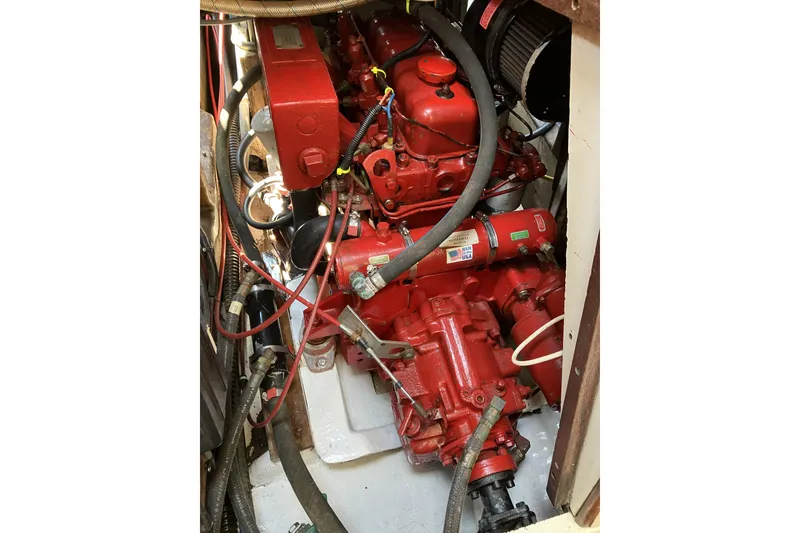 Slide: The Image of Engine compartment of a 1981 Pearson 365 Ketch sailboat, featuring a red marine engine. - 42