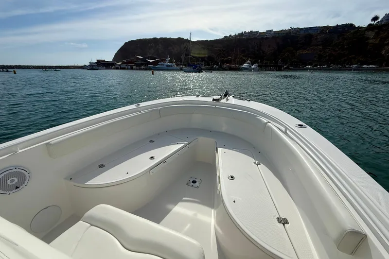 Slide: The Image of 2023 Edgewater 245CC boat interior with scenic harbor view in the background. - 12