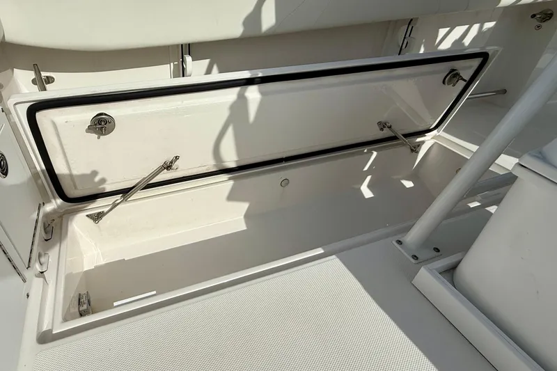 Slide: The Image of Open storage compartment on 2023 Edgewater 245CC boat, showcasing interior space and design. - 15