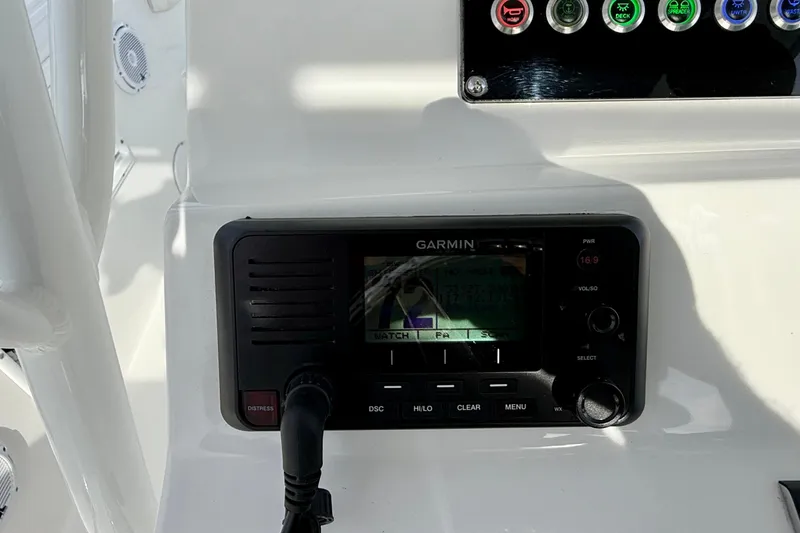 Slide: The Image of Garmin marine radio on 2023 Edgewater 245CC boat dashboard. - 17