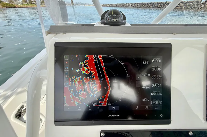 Slide: The Image of Garmin navigation display on 2023 Edgewater 245CC boat, showing radar and GPS data. - 18