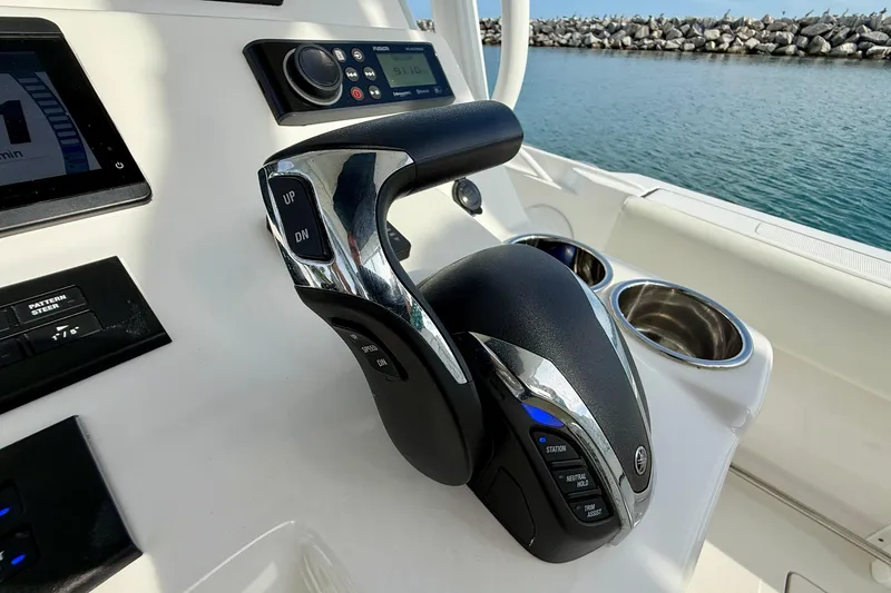 Slide: The Image of Control panel of 2023 Edgewater 245CC boat with throttle and navigation display. - 21