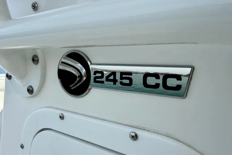 Slide: The Image of Edgewater 245CC 2023 model emblem on a sleek white boat exterior. - 28