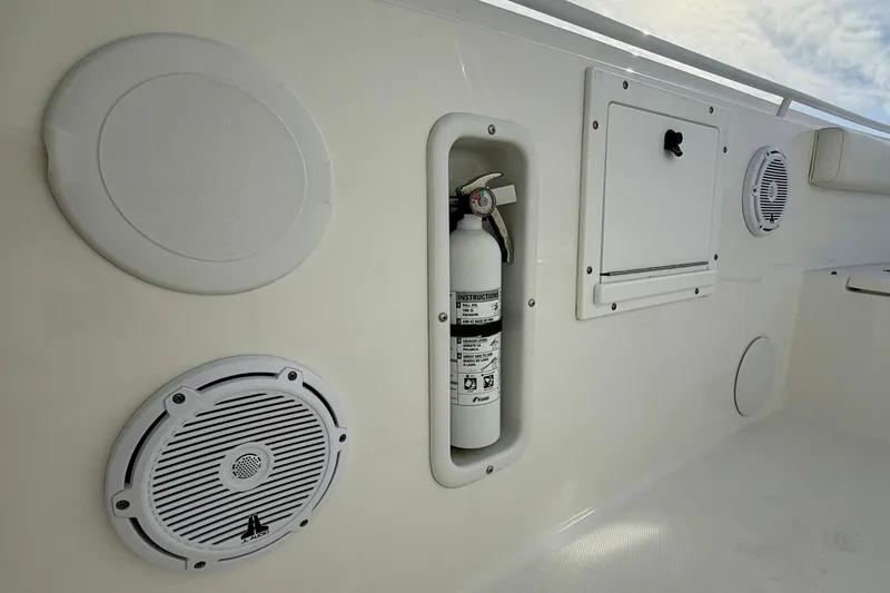 Slide: The Image of 2023 Edgewater 245CC boat interior with speakers and fire extinguisher. - 31