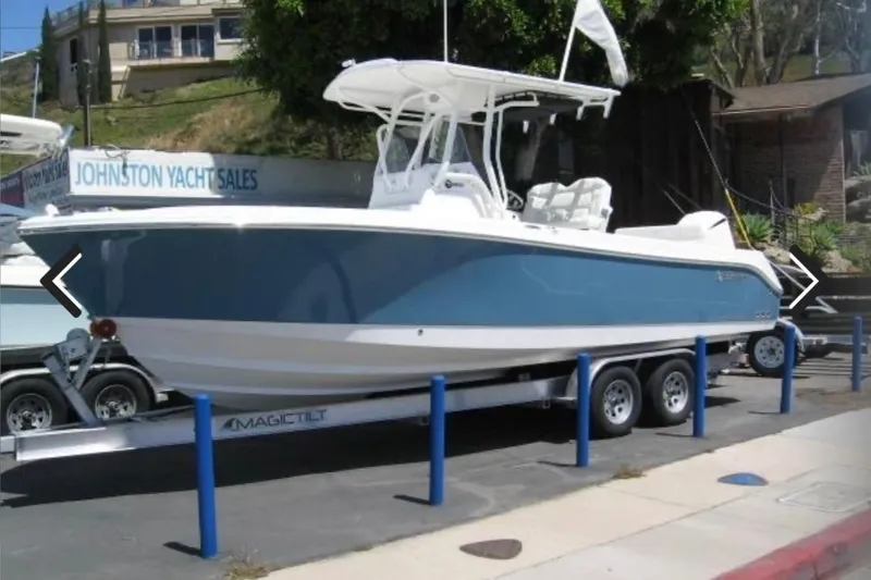 Slide: The Image of 2023 Edgewater 245CC boat on trailer at yacht sales location. - 6