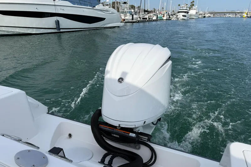 Slide: The Image of Edgewater 245CC 2023 boat with Yamaha outboard motor in a marina setting. - 7