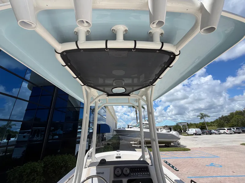 Slide: The Image of View from below of a Boston Whaler 210 Montauk's T-top with fishing rod holders. - 15