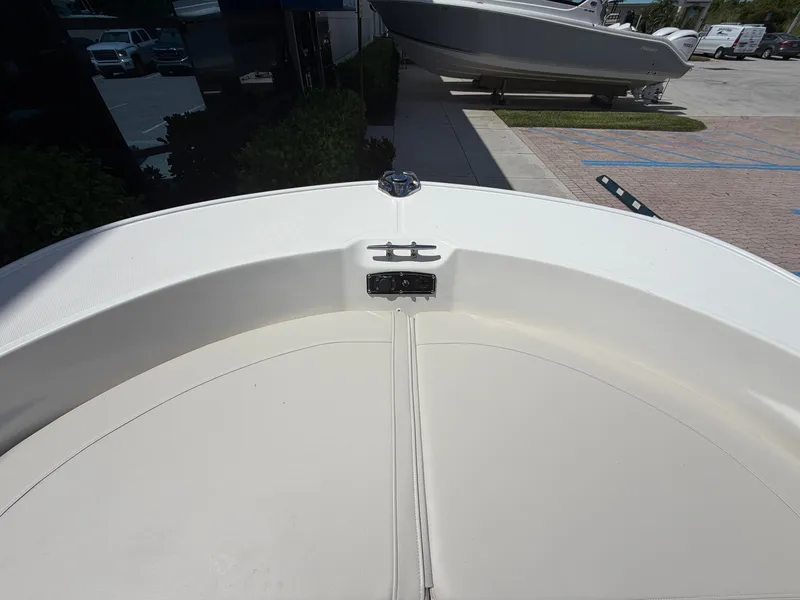 Slide: The Image of The image shows the bow of a Boston Whaler 210 Montauk, parked on a lot. - 27