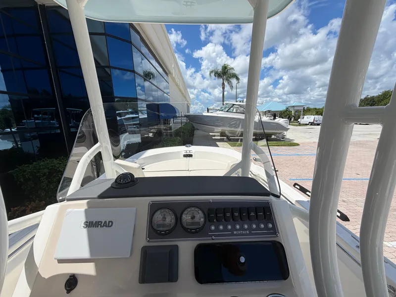 Slide: The Image of The cockpit of a 2027 Boston Whaler 210 Montauk with modern instruments and a blue sky. - 22