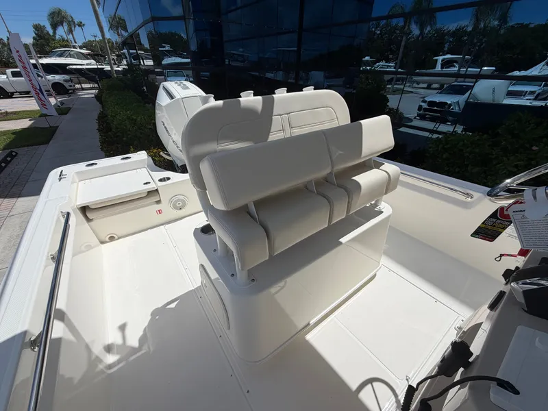 Slide: The Image of The image shows the cockpit of a Boston Whaler 210 Montauk with white cushioned seats. - 18