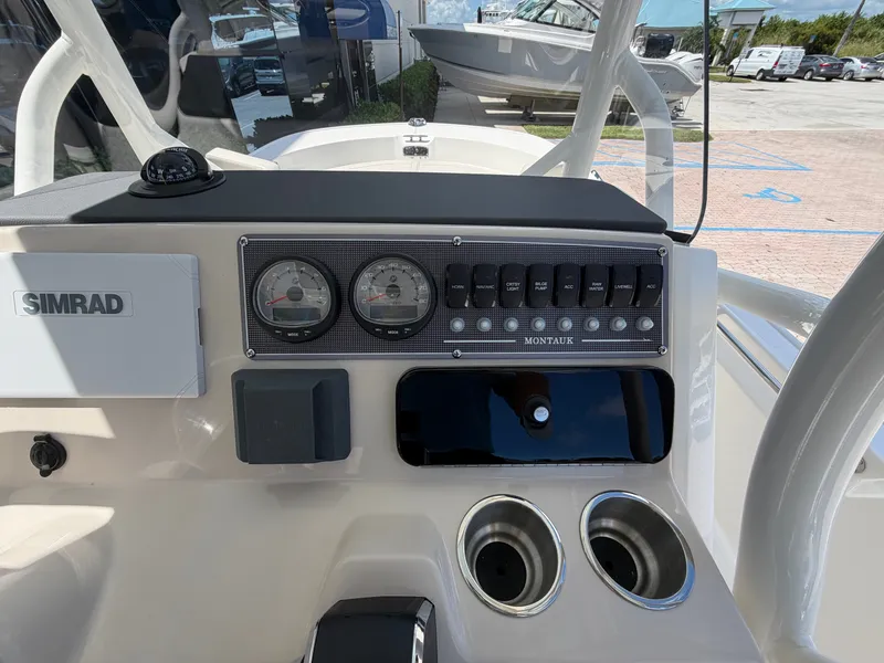 Slide: The Image of Dashboard of a Boston Whaler 210 Montauk with instruments and cup holders. - 21